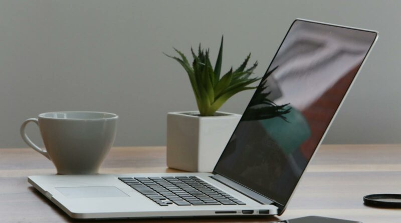 Silver Laptop and White Cup on Table