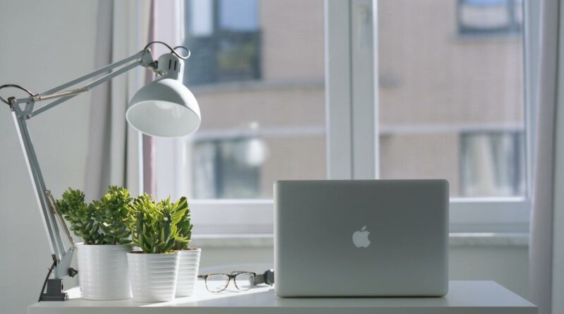 Silver Macbook Air and Goose Neck Lamp